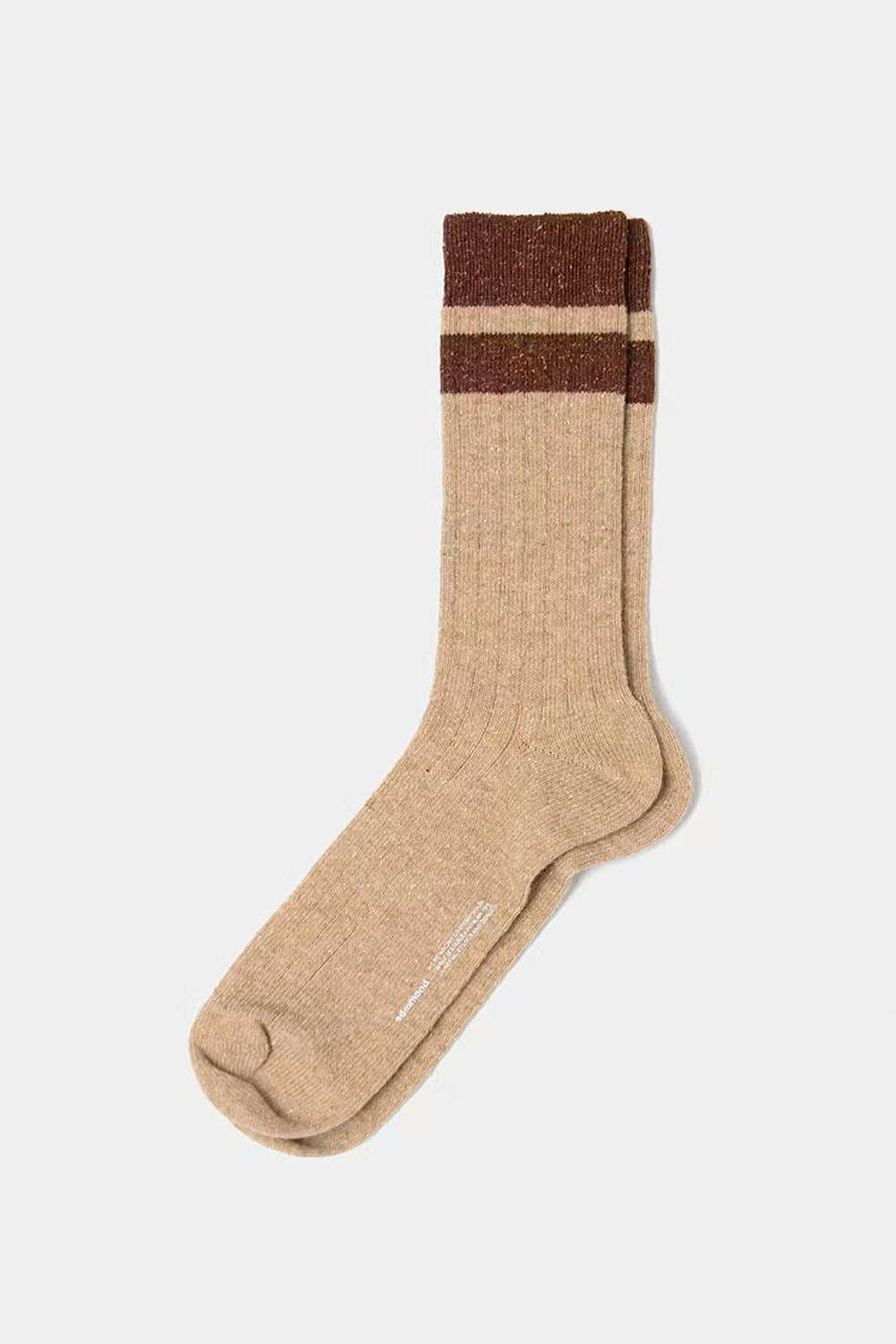 A pair of beige crew socks with two dark brown horizontal stripes near the ribbed cuff, displayed on a light gray background.