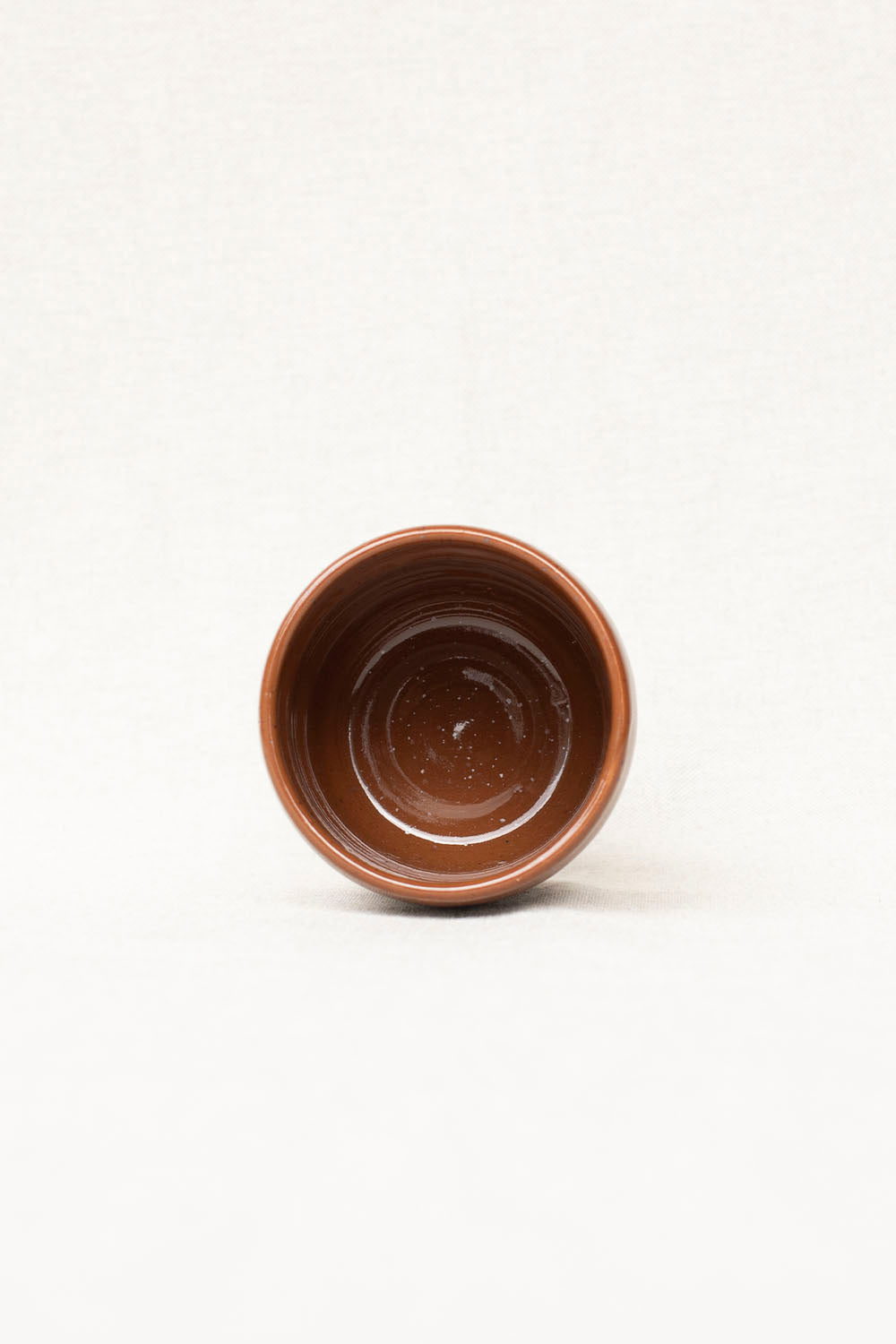 Brown ceramic cup on a white background