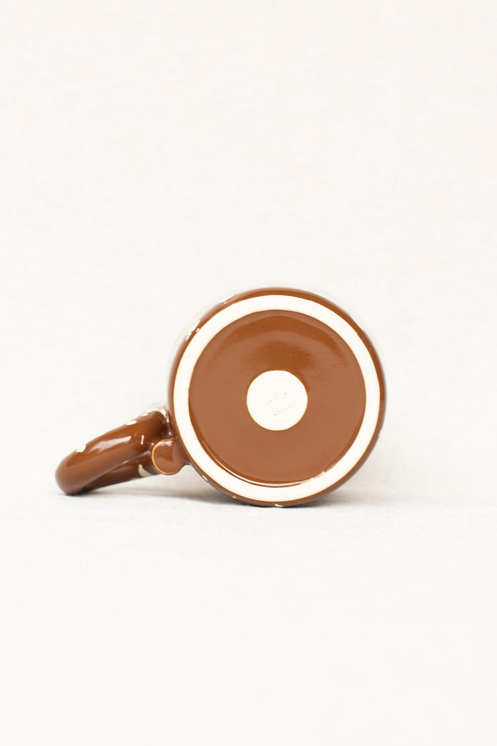 Brown donut-shaped object on a white background
