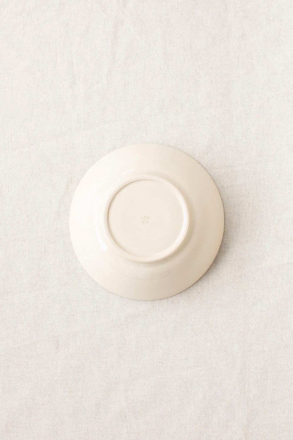 White ceramic bowl on a textured white surface