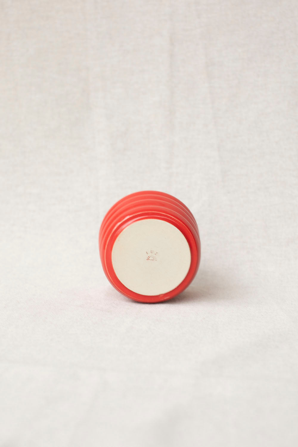 Red ceramic container on a white background