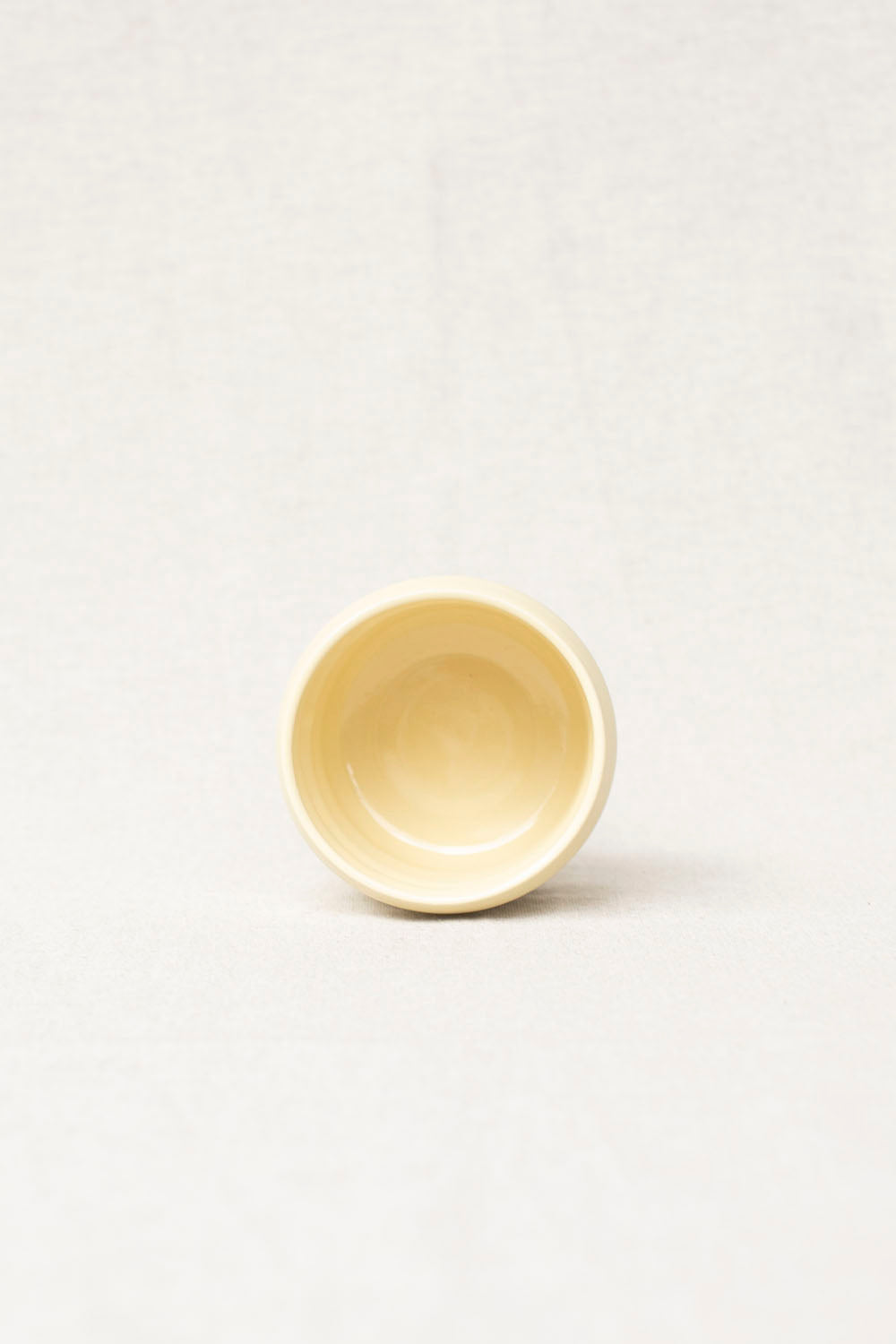 Yellow ceramic bowl on a white background