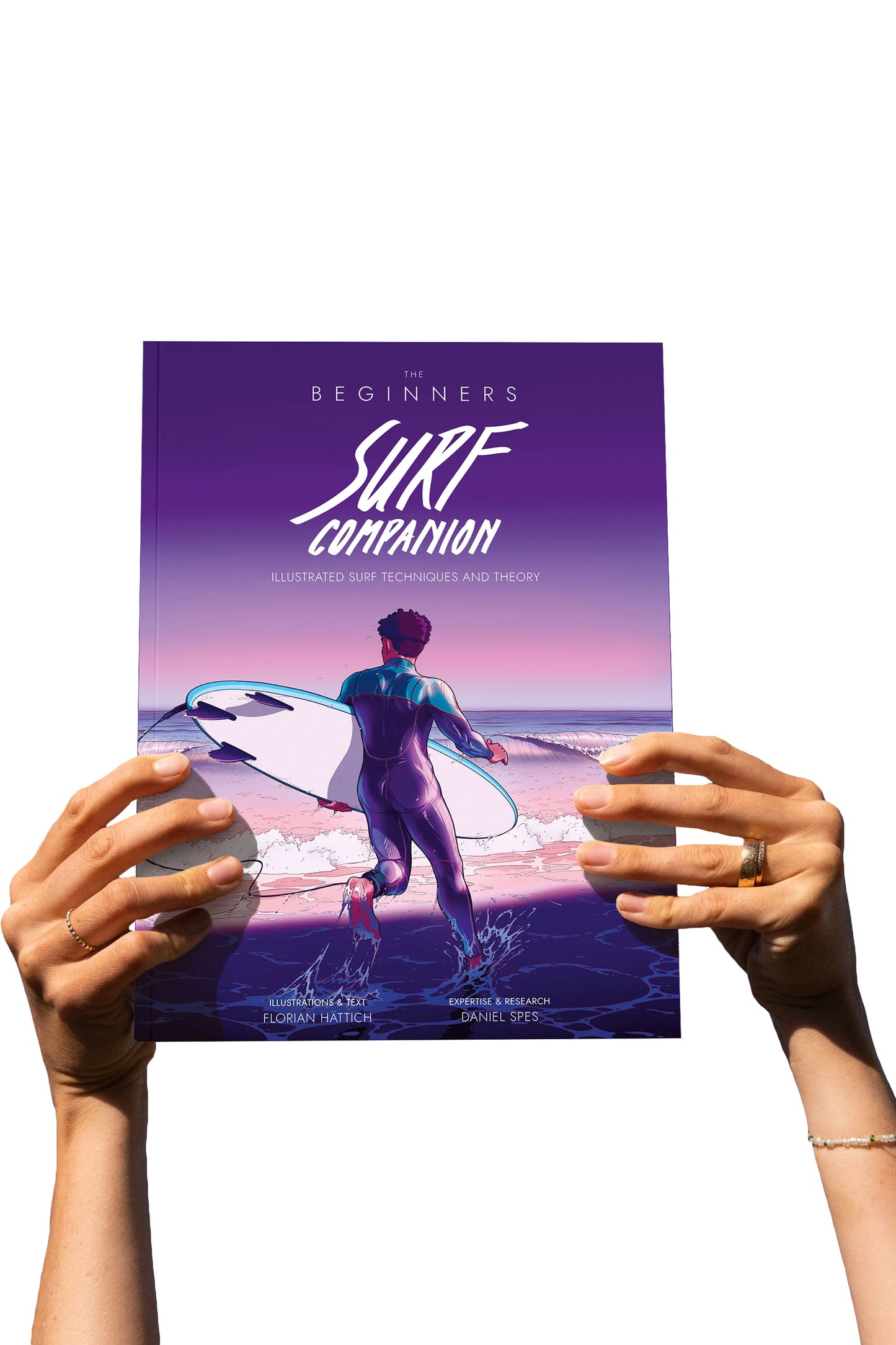 Hands holding The Beginners Surf Companion book upright