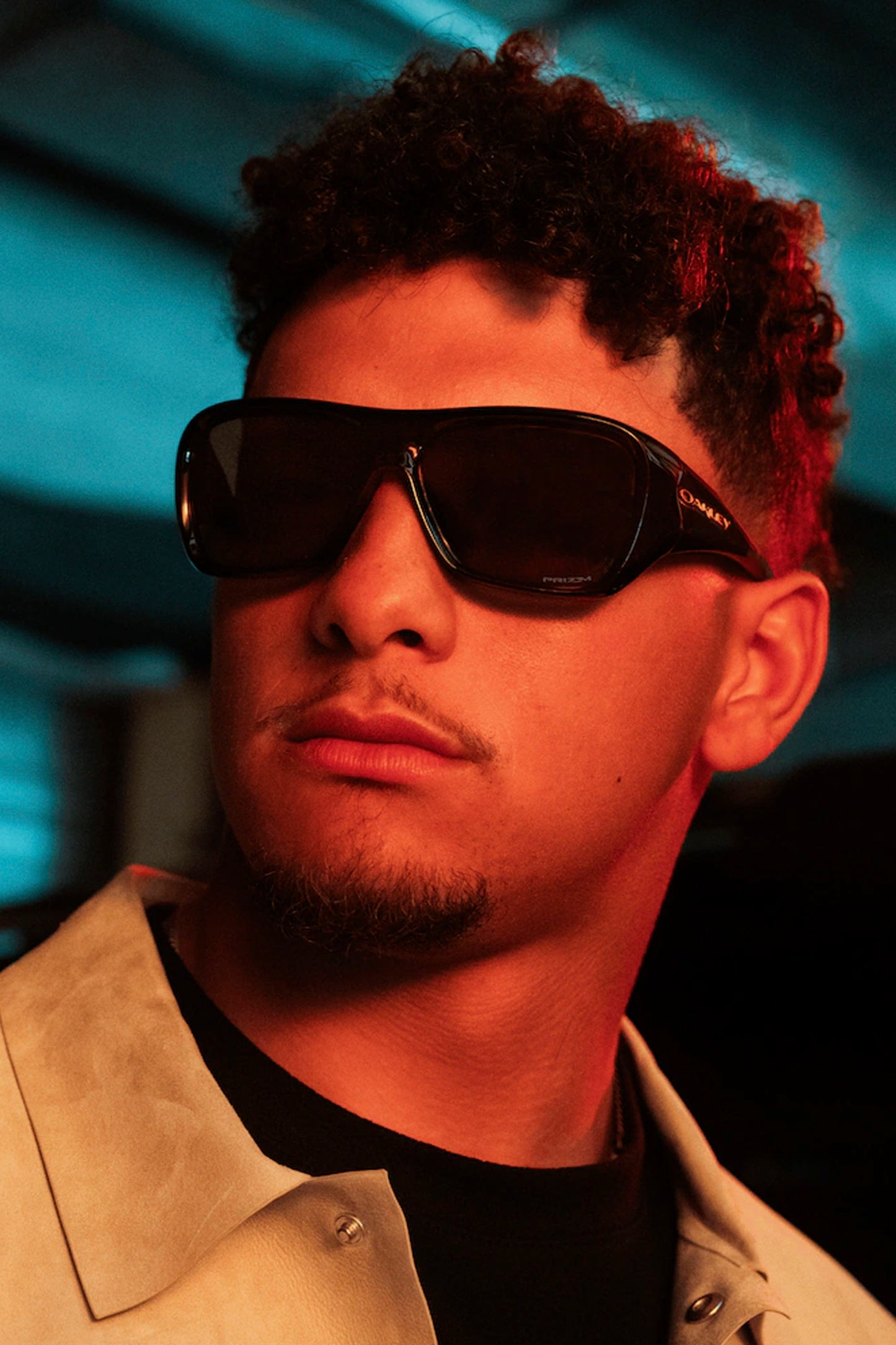 Person wearing Black Oakley Chaminade sunglasses with a dark background