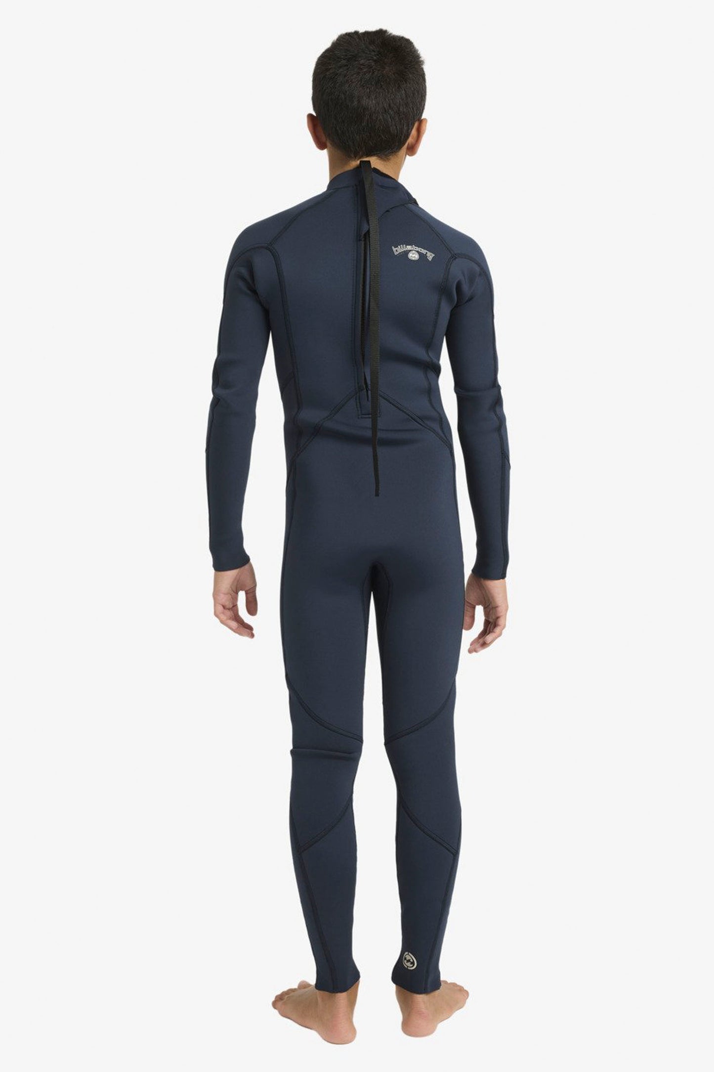 Boy wearing a Billabong Absolute 3/2mm navy wetsuit on a white background