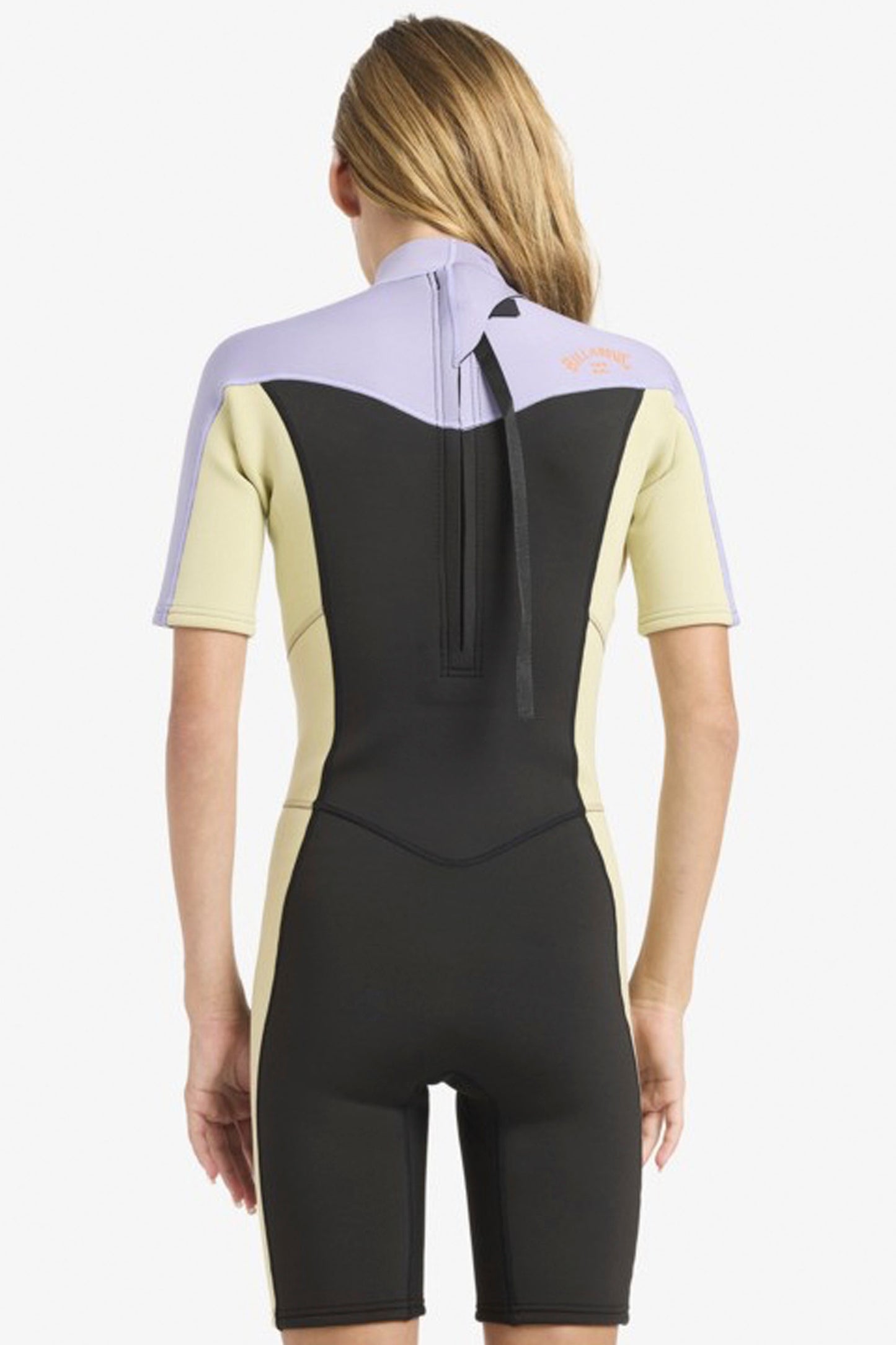 Teenager wearing a black and purple Billabong 2/2mm springsuit on a white background