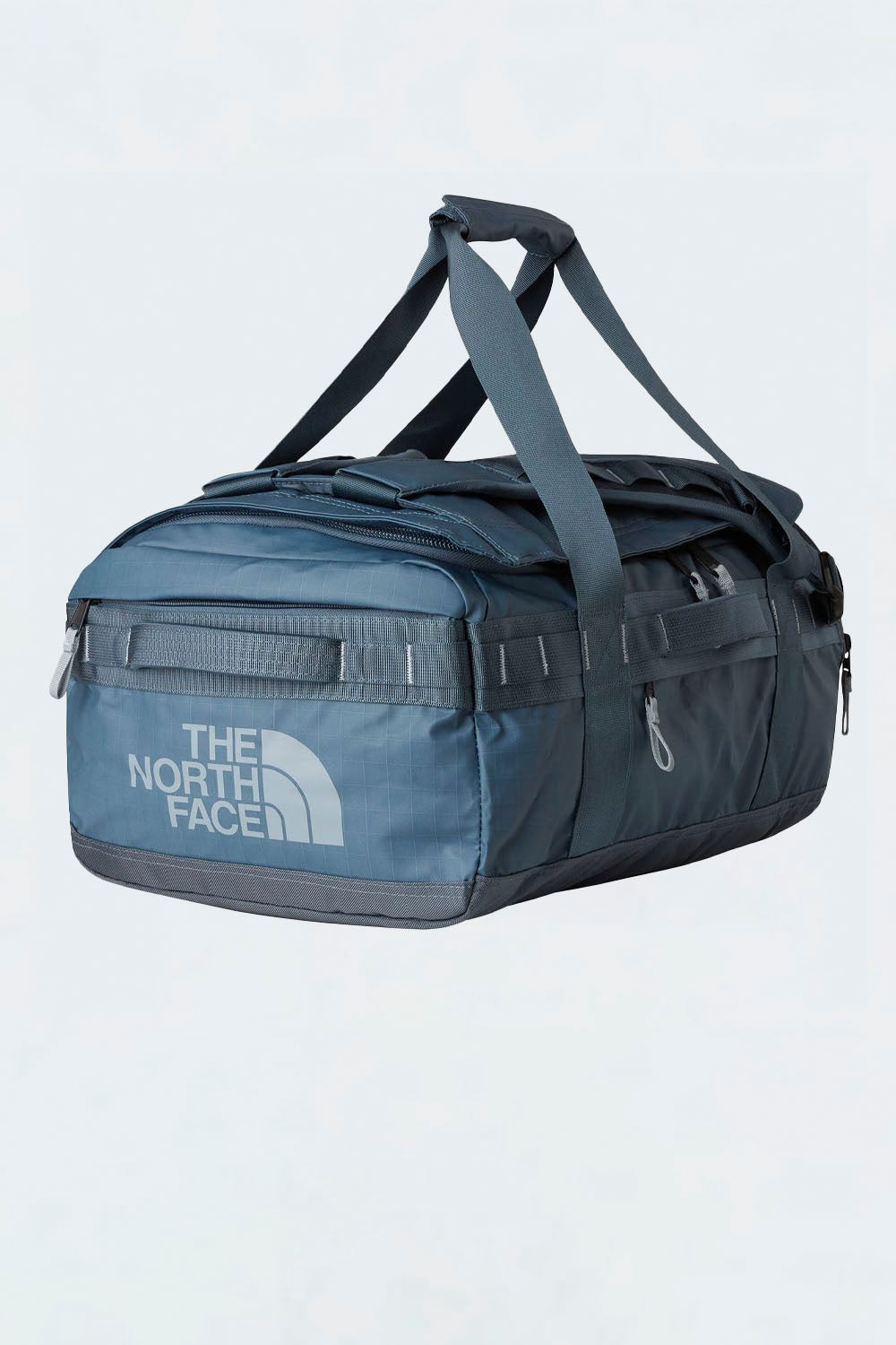 Blue duffel bag with The North Face logo on a light gray background