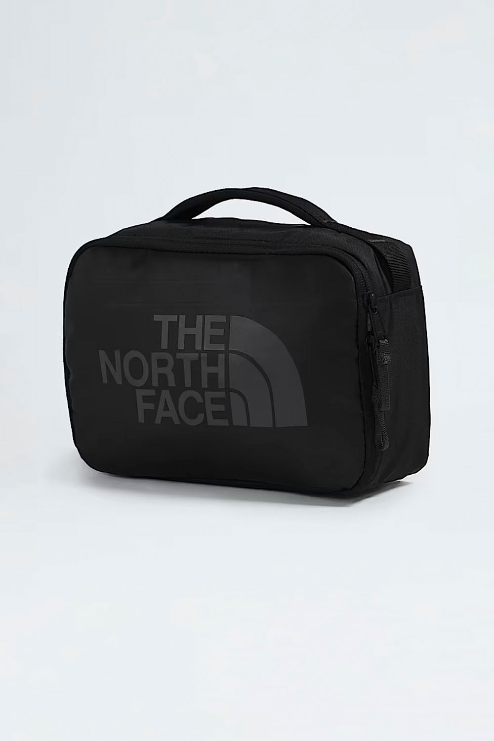 Black The North Face travel bag on a light gray background