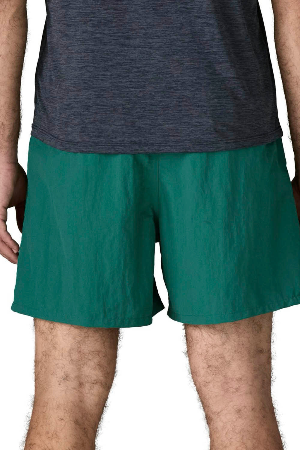 A close-up of a person wearing teal green athletic shorts and a dark heather gray t-shirt, cropped from the chest down against a white background.