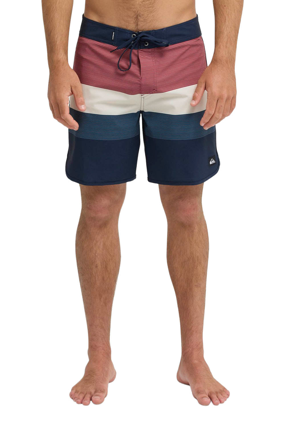 Multicolored swim shorts worn by a person on a white background