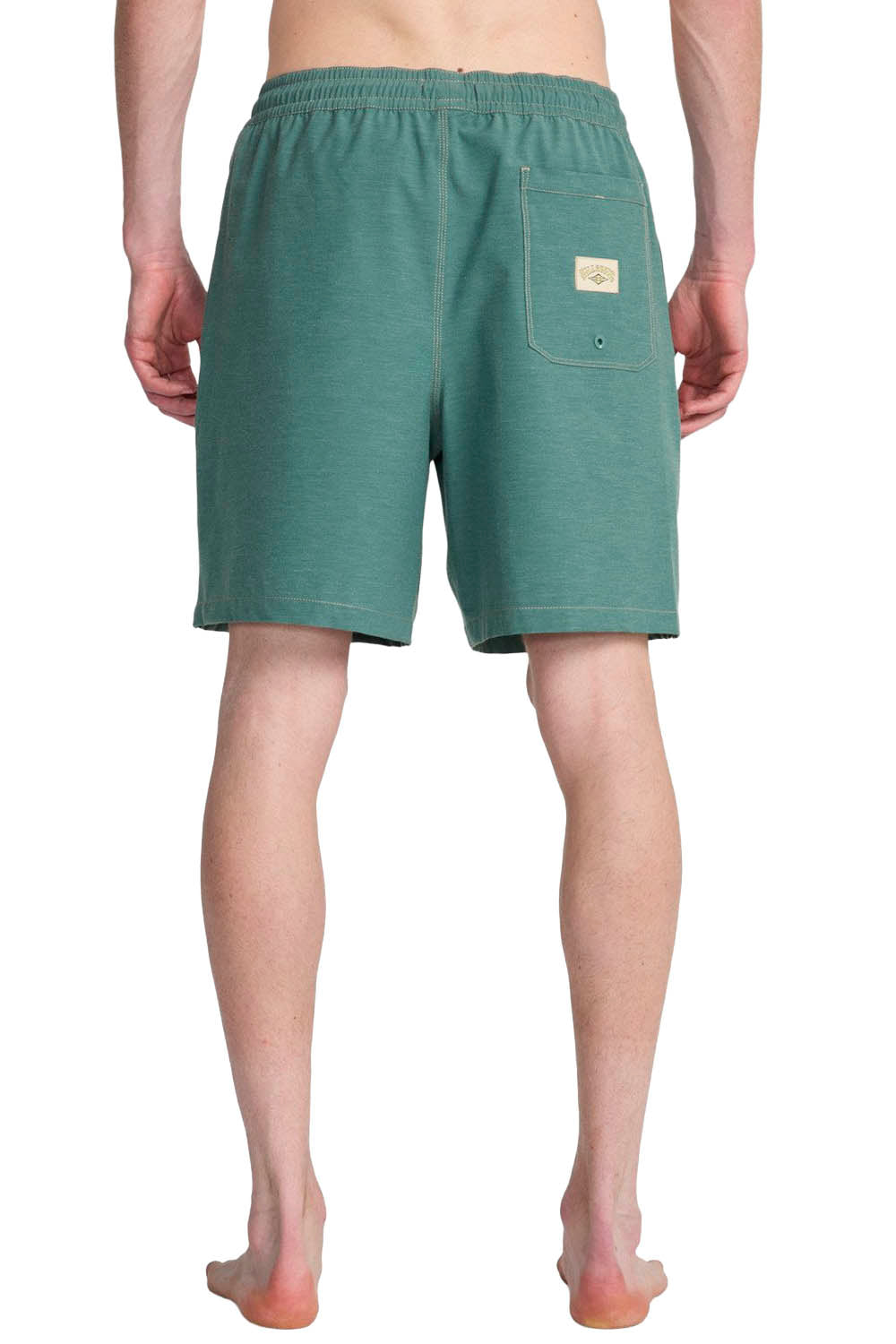 Green boardshorts with a Billabong logo on a white background