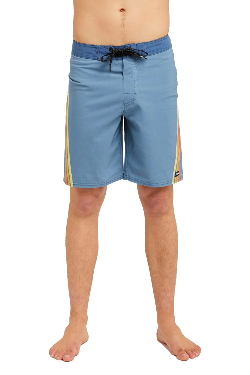 Blue and yellow board shorts worn by a person on a white background