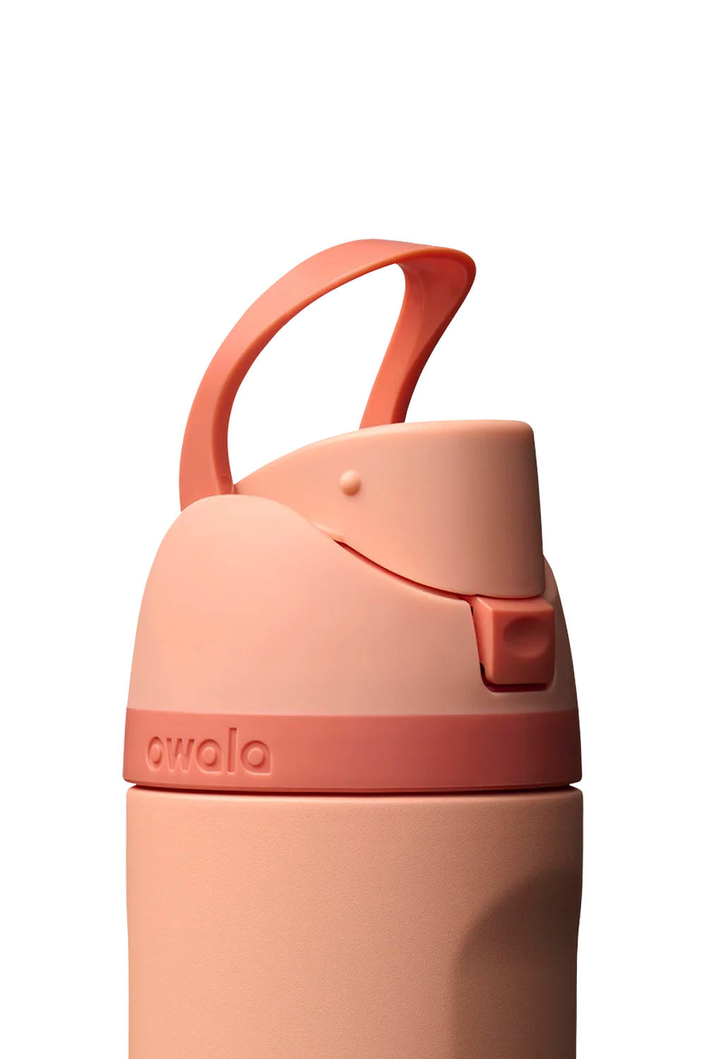 A close-up of a water bottle lid in a soft peach-pink color, featuring a matching carrying loop and the embossed brand name 'owala' on a coral band, set against a plain white background.