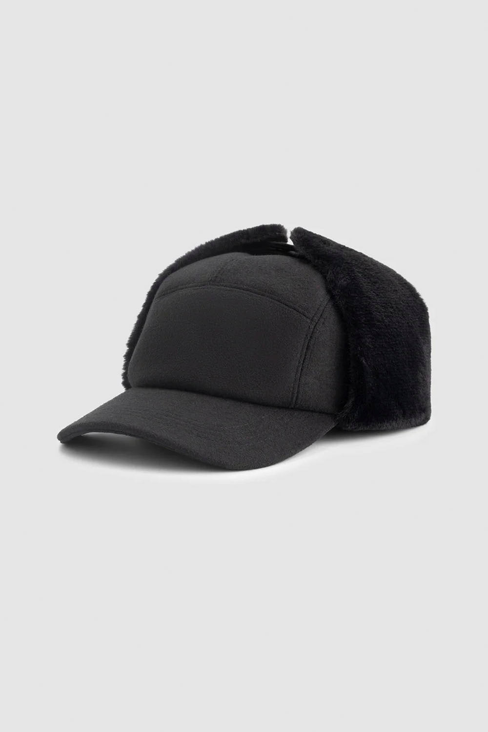 Black trucker cap with green triangle design on a white background