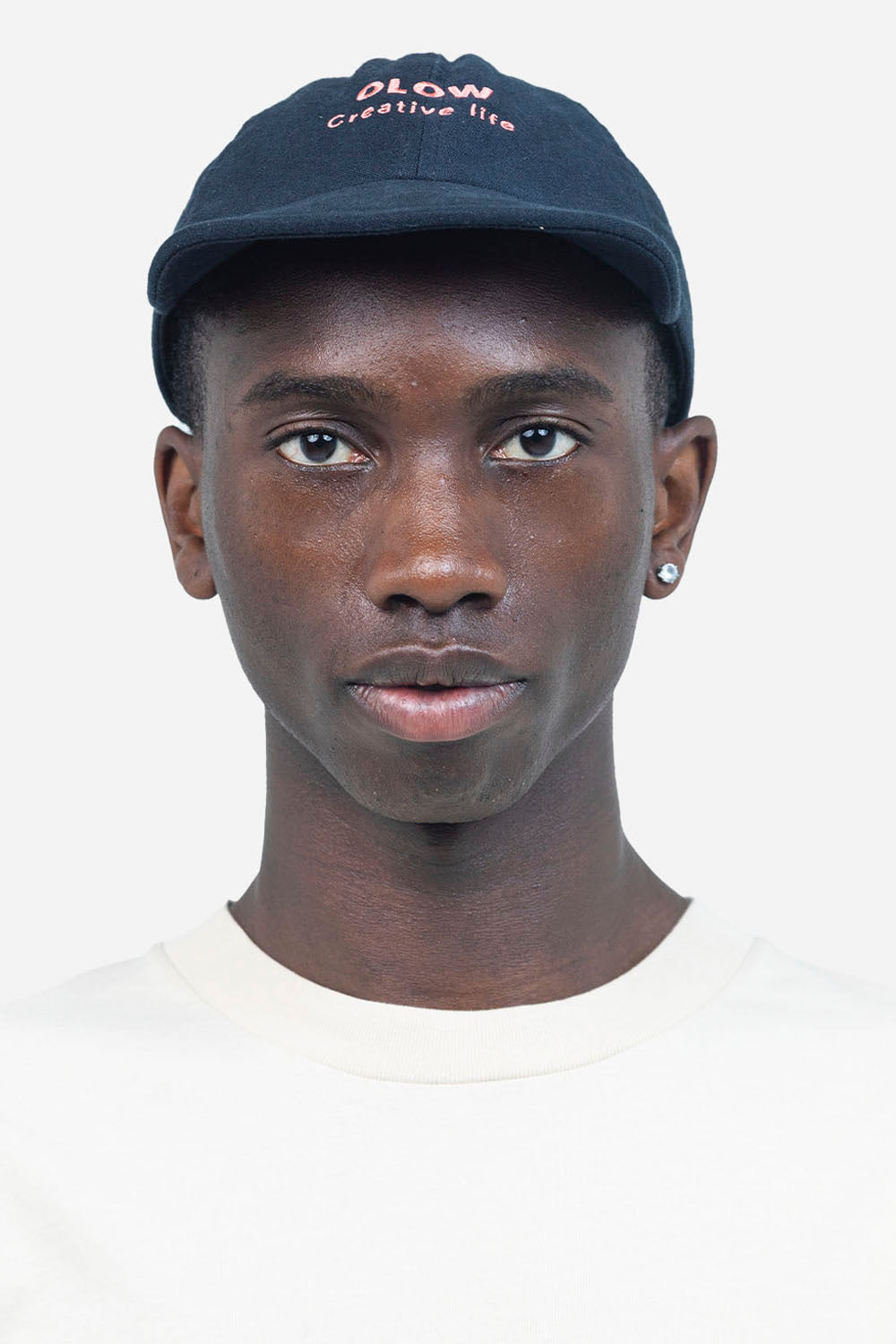 Person wearing a navy cap with text on a white background