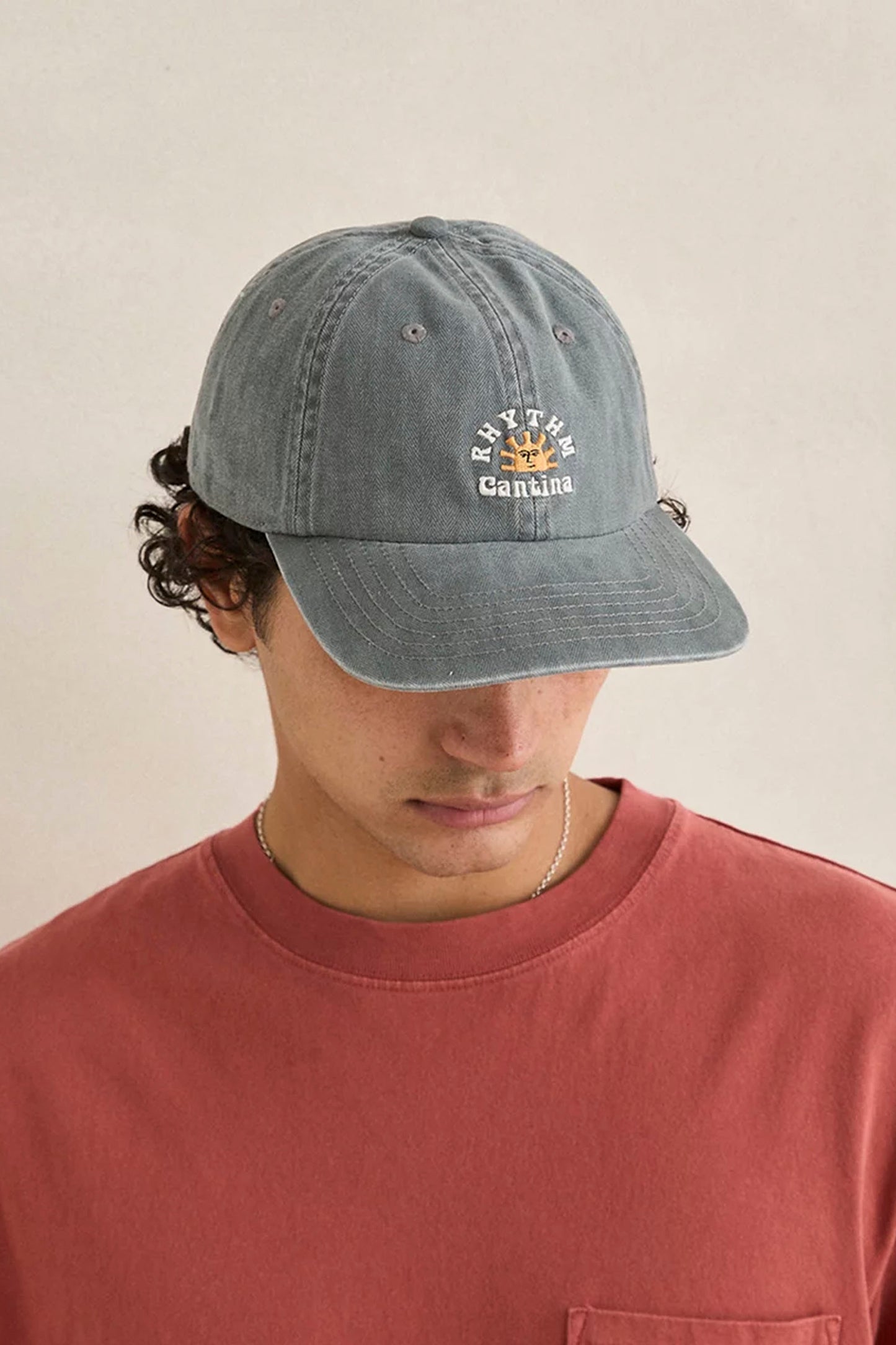 Person wearing Rhythm Cantina Cap on a beige background