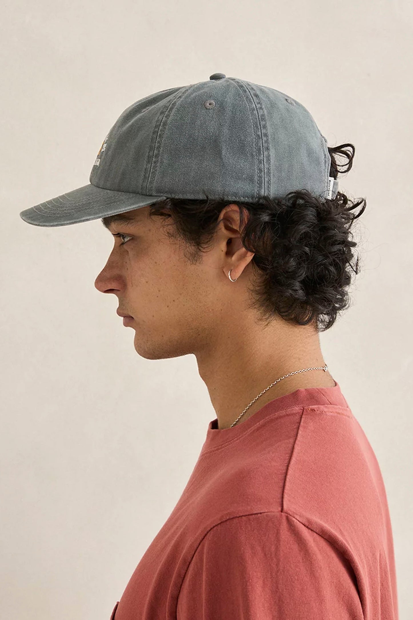 Person wearing Rhythm Cantina Cap on a beige background