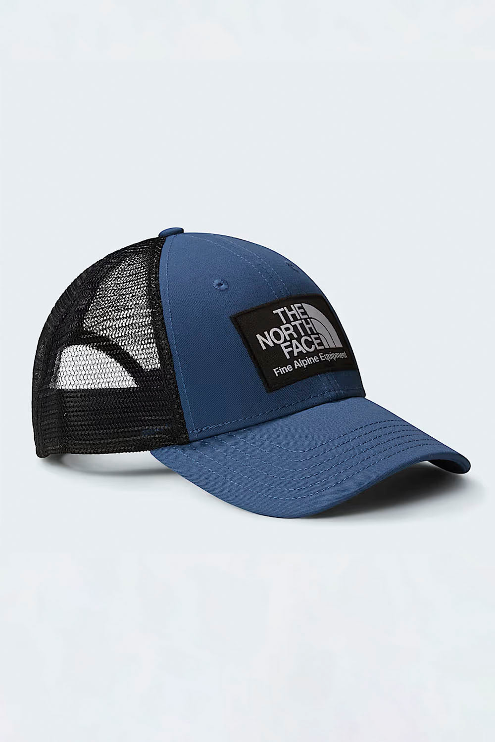 Blue and black cap with The North Face logo on a light gray background