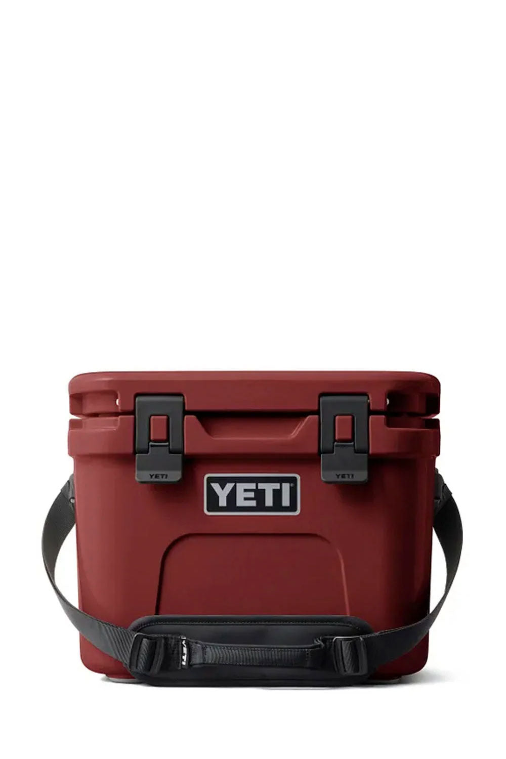 The bottom view of a YETI cooler in a deep red color, showing the embossed YETI logo, four gray corner protectors, and black latches on a white background.