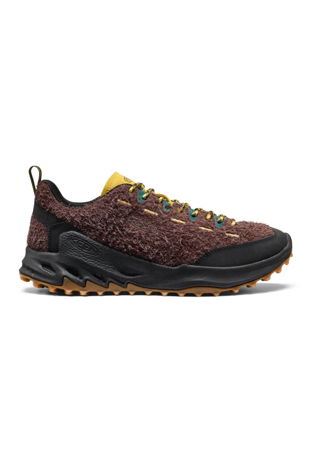 Pair of brown sneakers with yellow laces on a white background