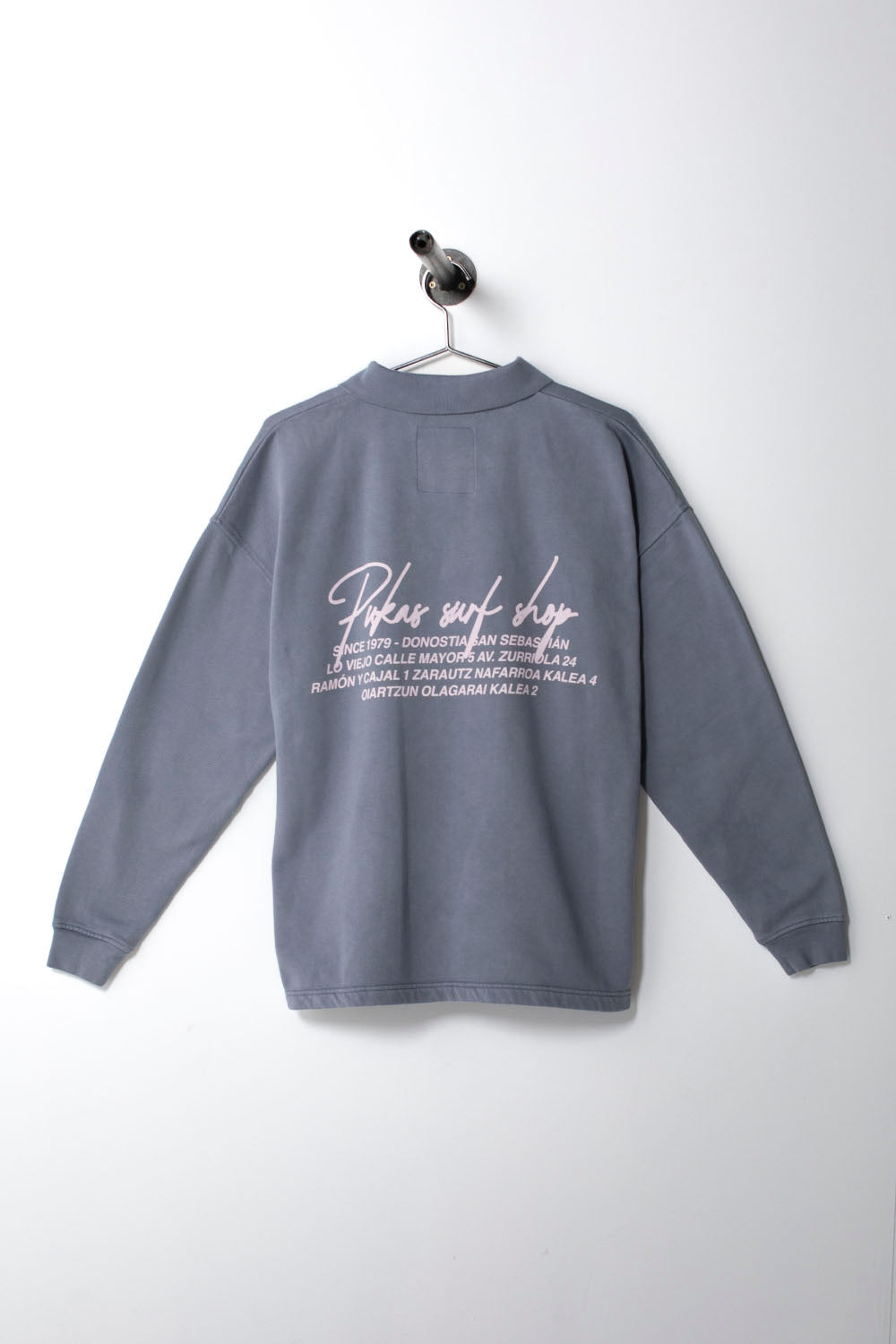 Gray sweatshirt with white text on a hanger against a white background