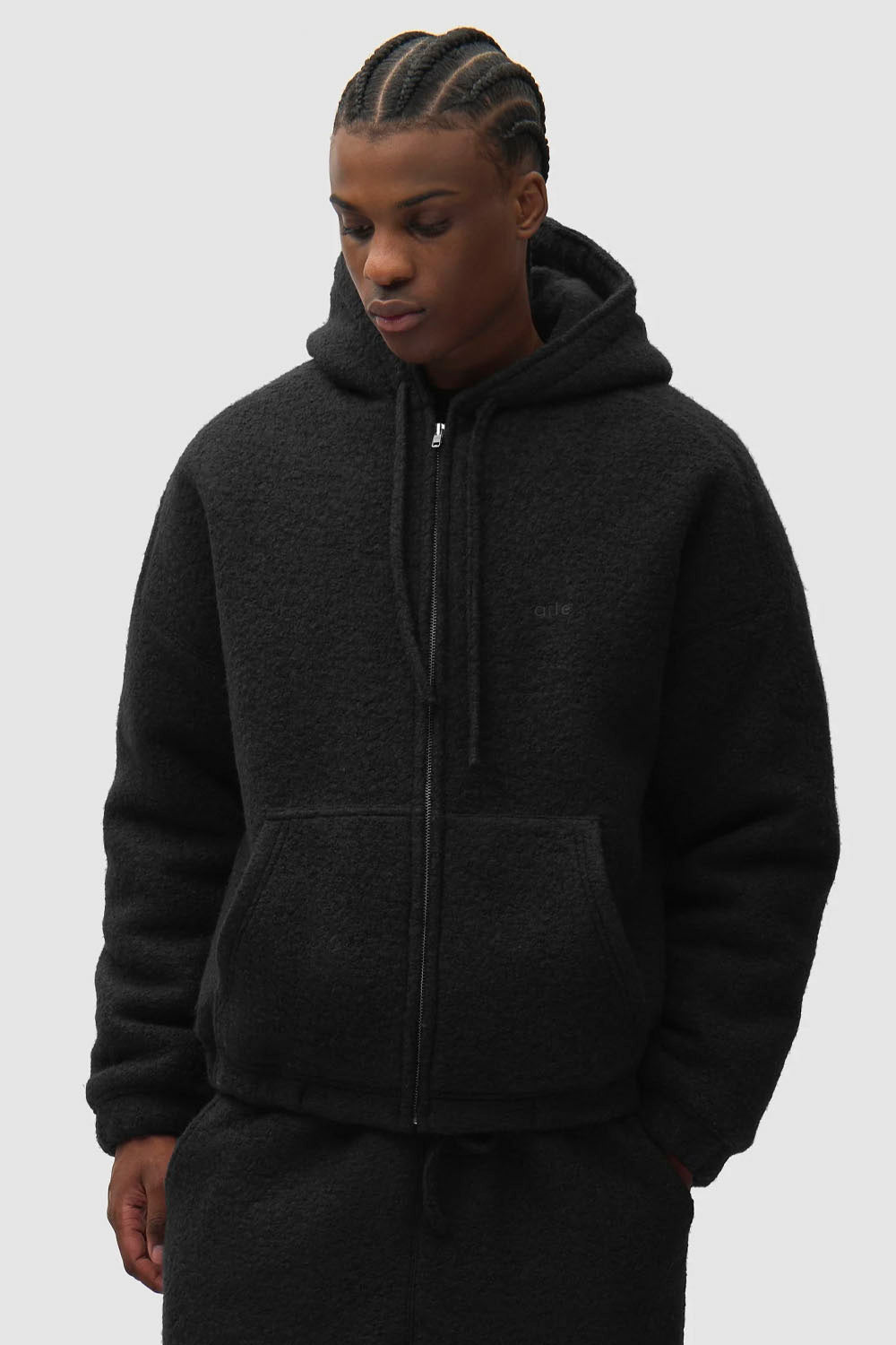 “ARTE Boiled Wool Hooded Jacket in black with front zip, drawstring hood and patch pockets
