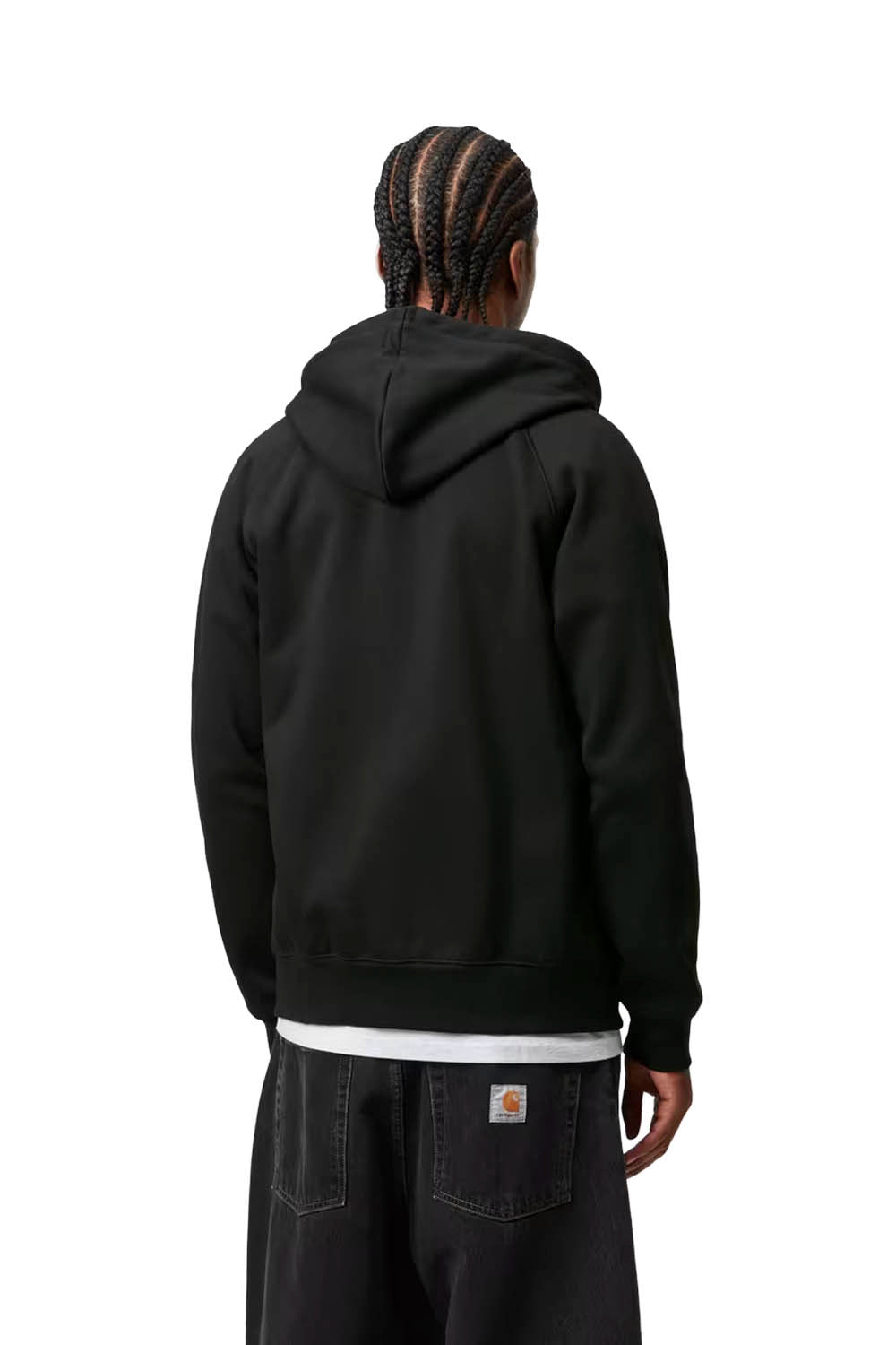 Man wearing a black hooded jacket over a white shirt on a white background