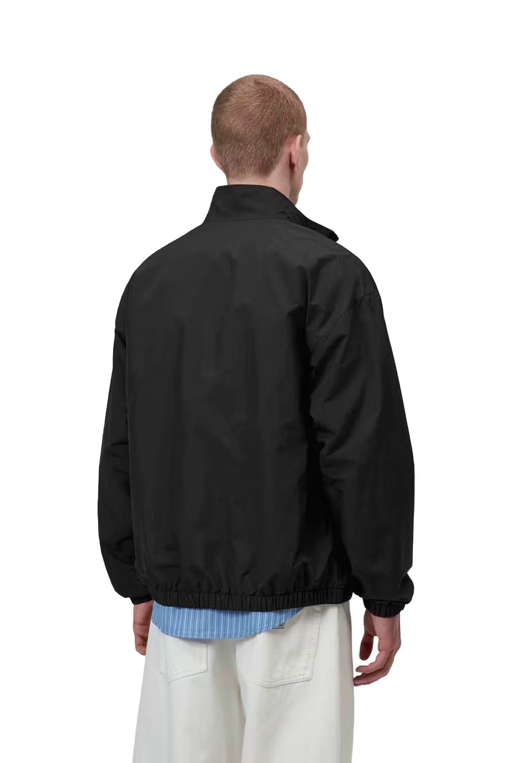 Person wearing a black jacket on a white background