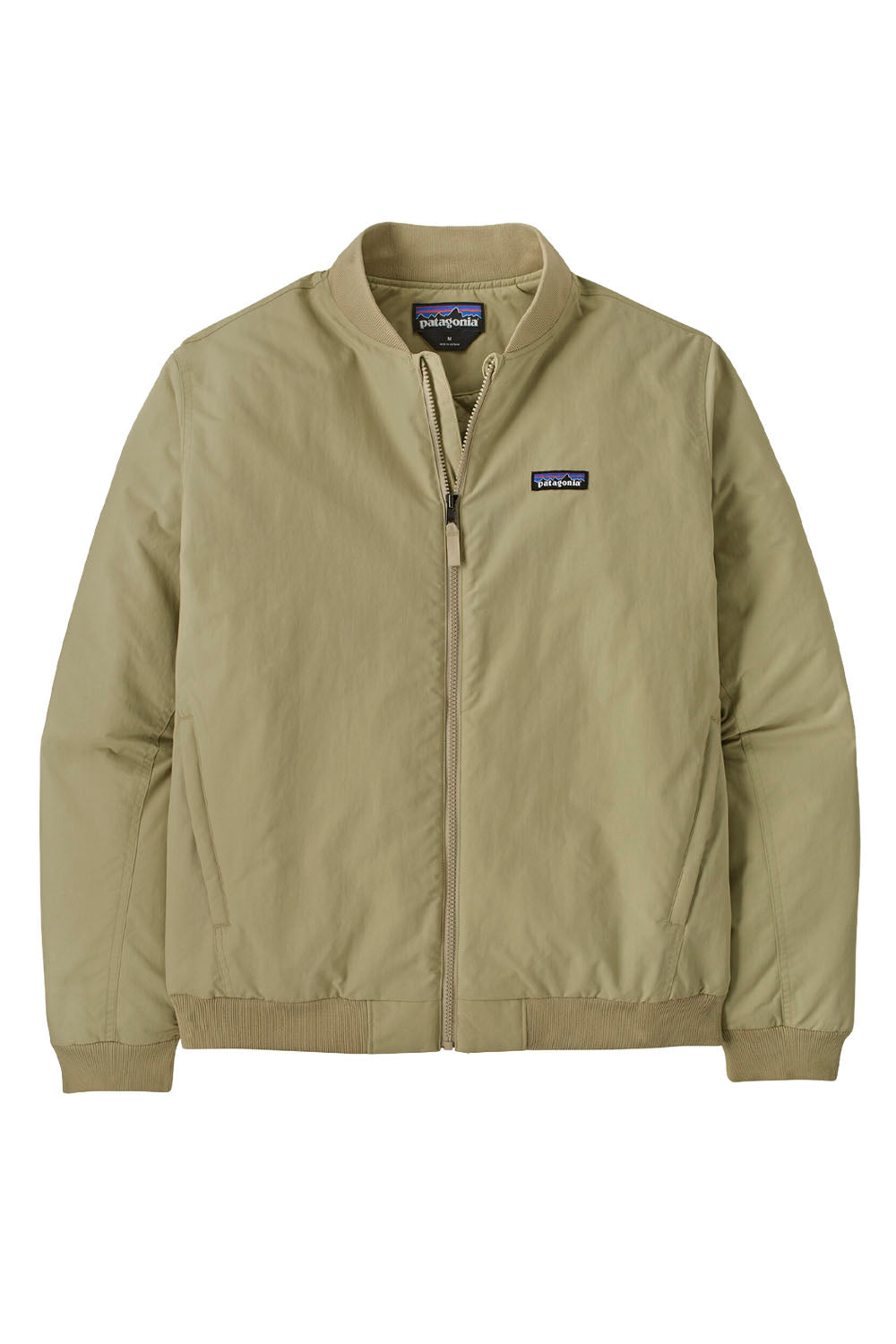 A Patagonia zip-up jacket in a light khaki color, featuring a stand-up collar, front zipper, and the brand's logo patch on the left chest, displayed against a solid white background.