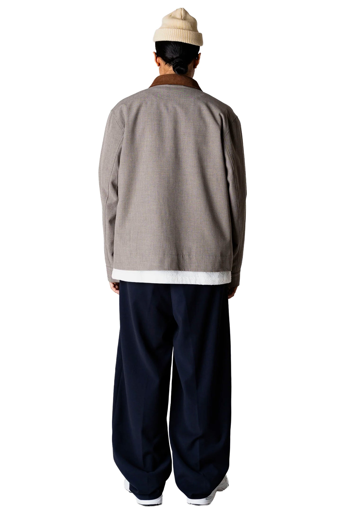 Person wearing a Woodbird Wbpon Guan Work jacket and navy pants with a white background