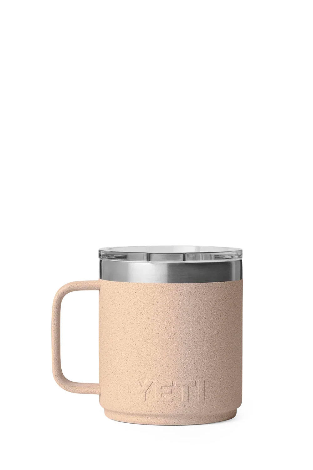 A YETI insulated travel mug in a textured light beige color, featuring a clear lid with a white silicone seal and a matching beige handle, shown on a solid white background.