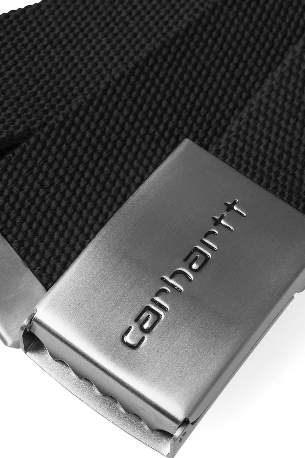 Close-up of a Carhartt belt buckle on a black webbing belt.