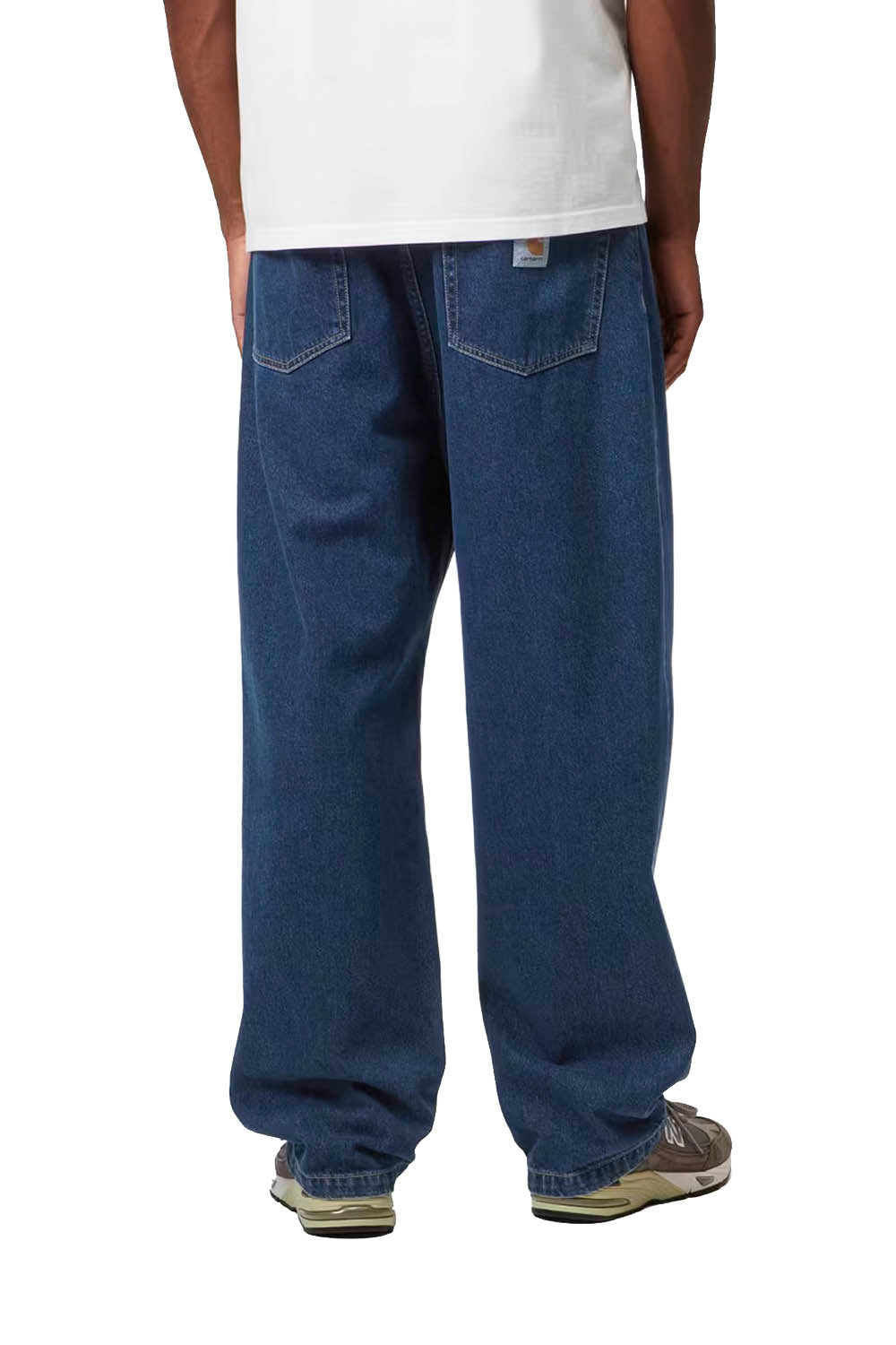 Man wearing a white Carhartt t-shirt and blue jeans on a white background