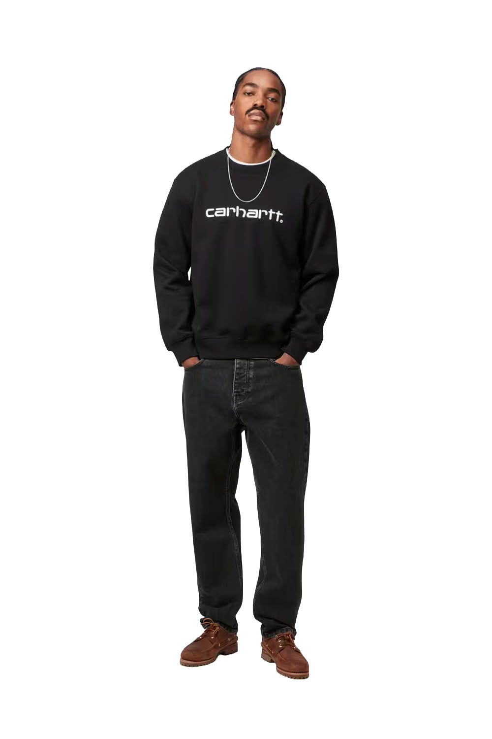 Person wearing a black Carhartt sweatshirt and jeans on a white background