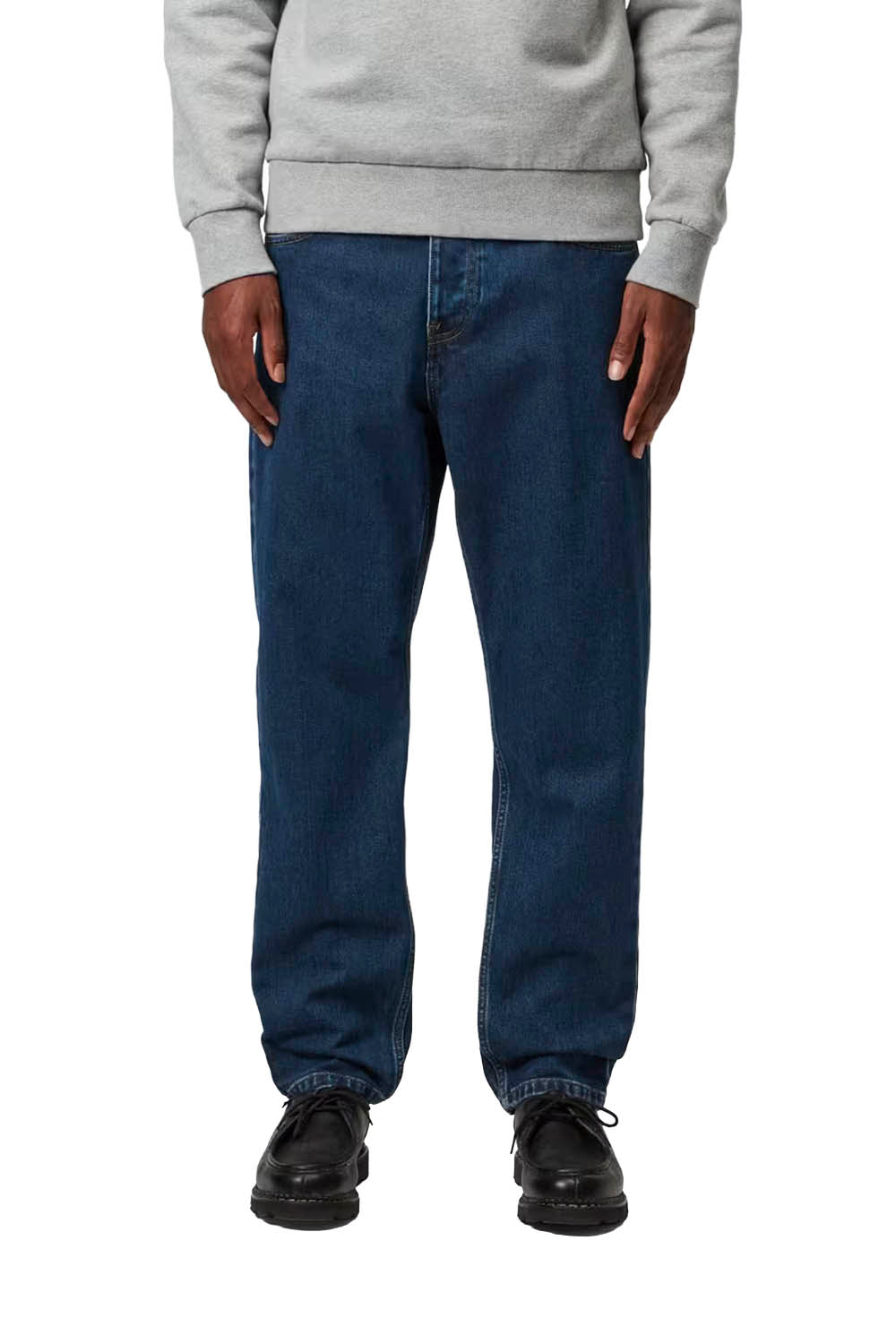 Man wearing a gray sweatshirt and blue jeans on a white background