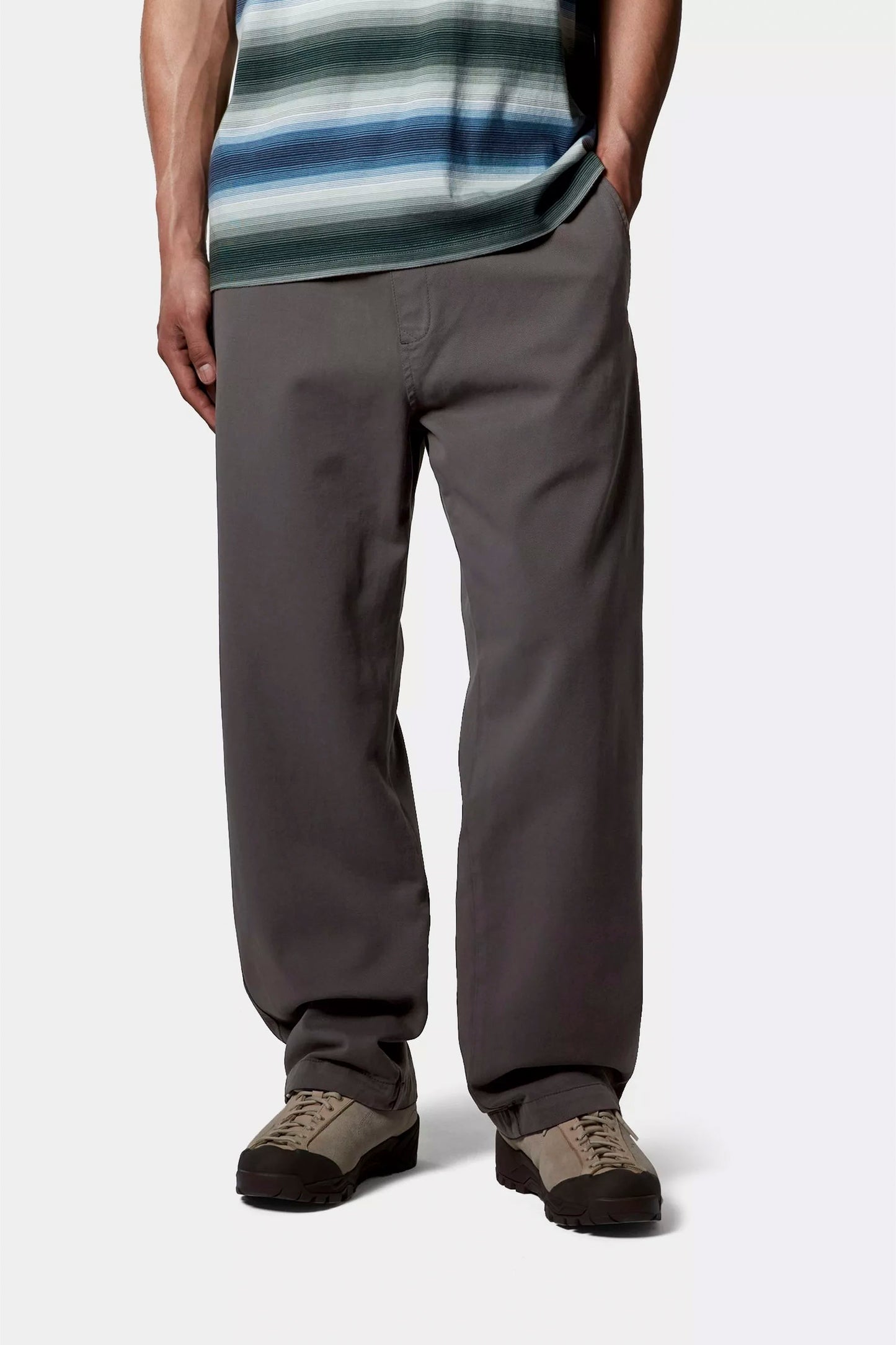 Person wearing Carhartt Floyde graphite pants and a striped shirt on a white background