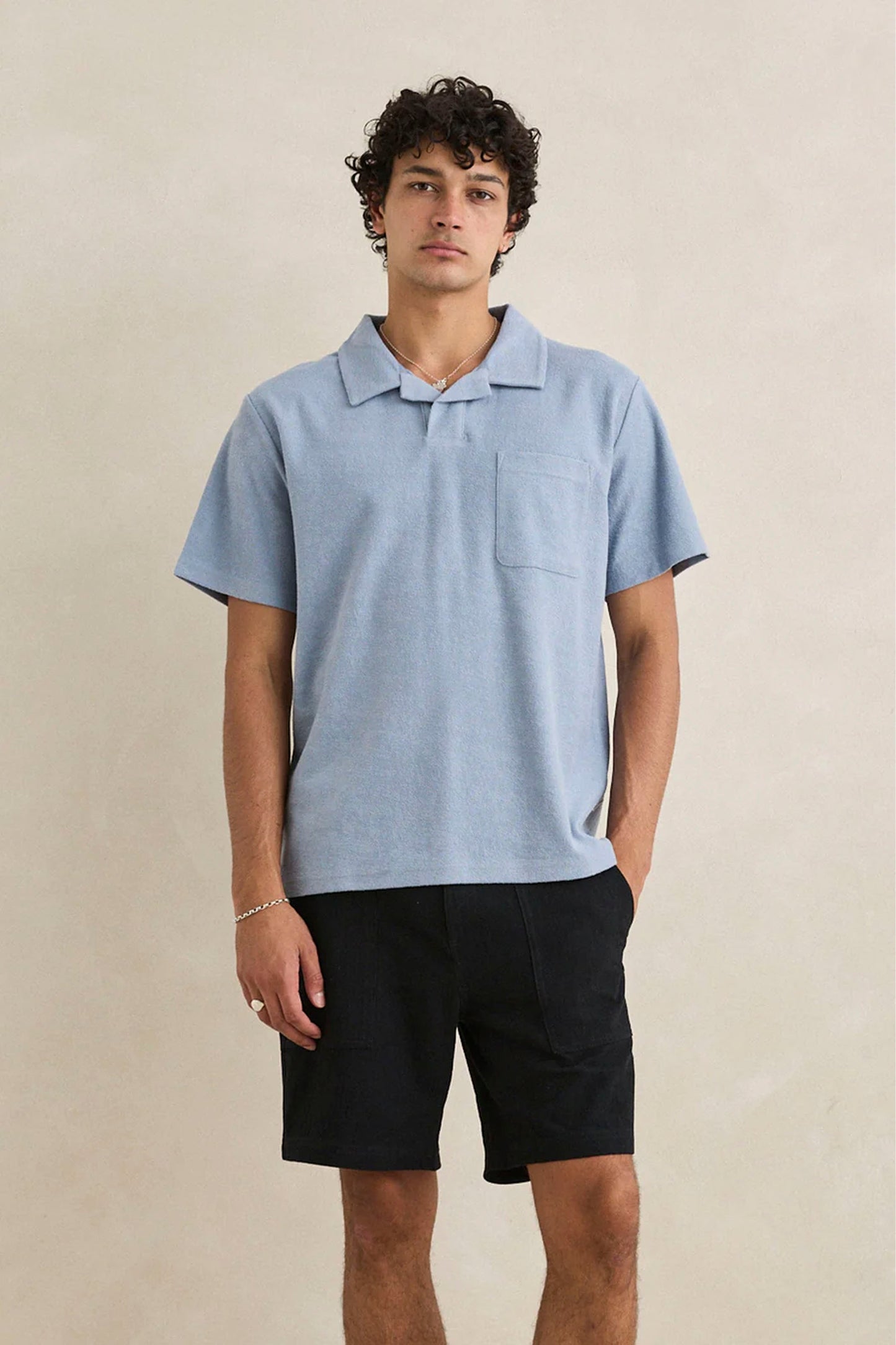 Man wearing Rhythm blue terry polo - lifestyle shot showcasing vintage fit and relaxed style