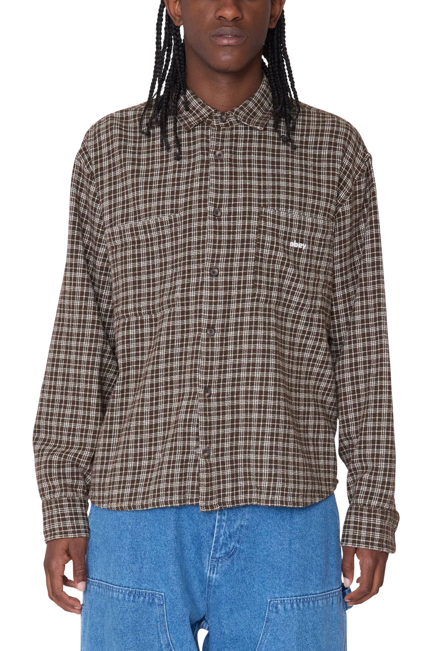 Person wearing a OBEY brown plaid shirt Pukas Surf Shop 