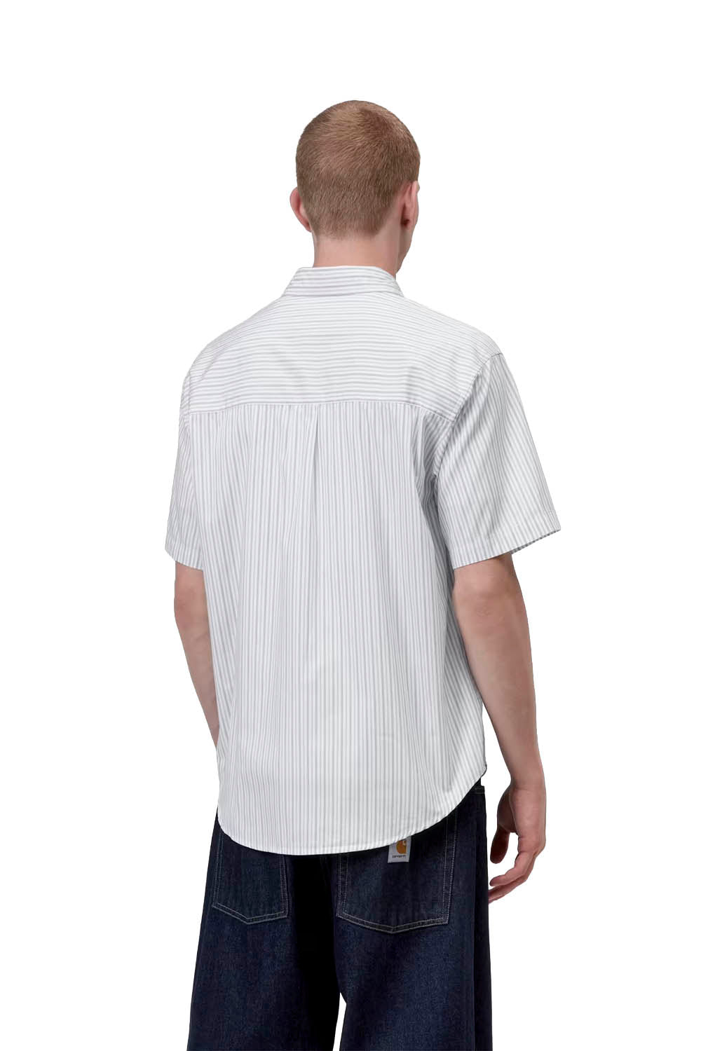 Man wearing a white striped shirt and dark pants on a white background