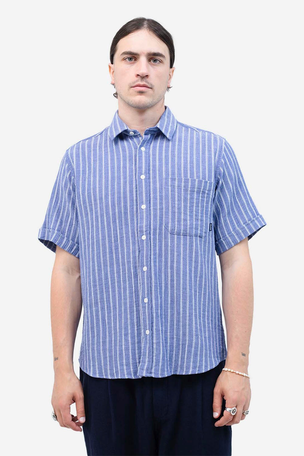 Man wearing a blue and white striped shirt on a white background