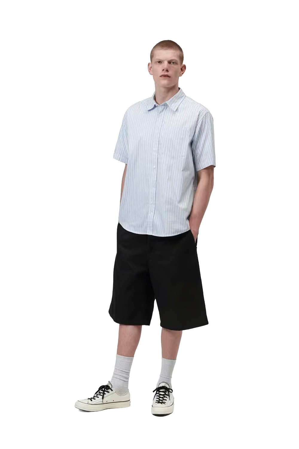 Person wearing a white and blue striped shirt with black shorts on a white background