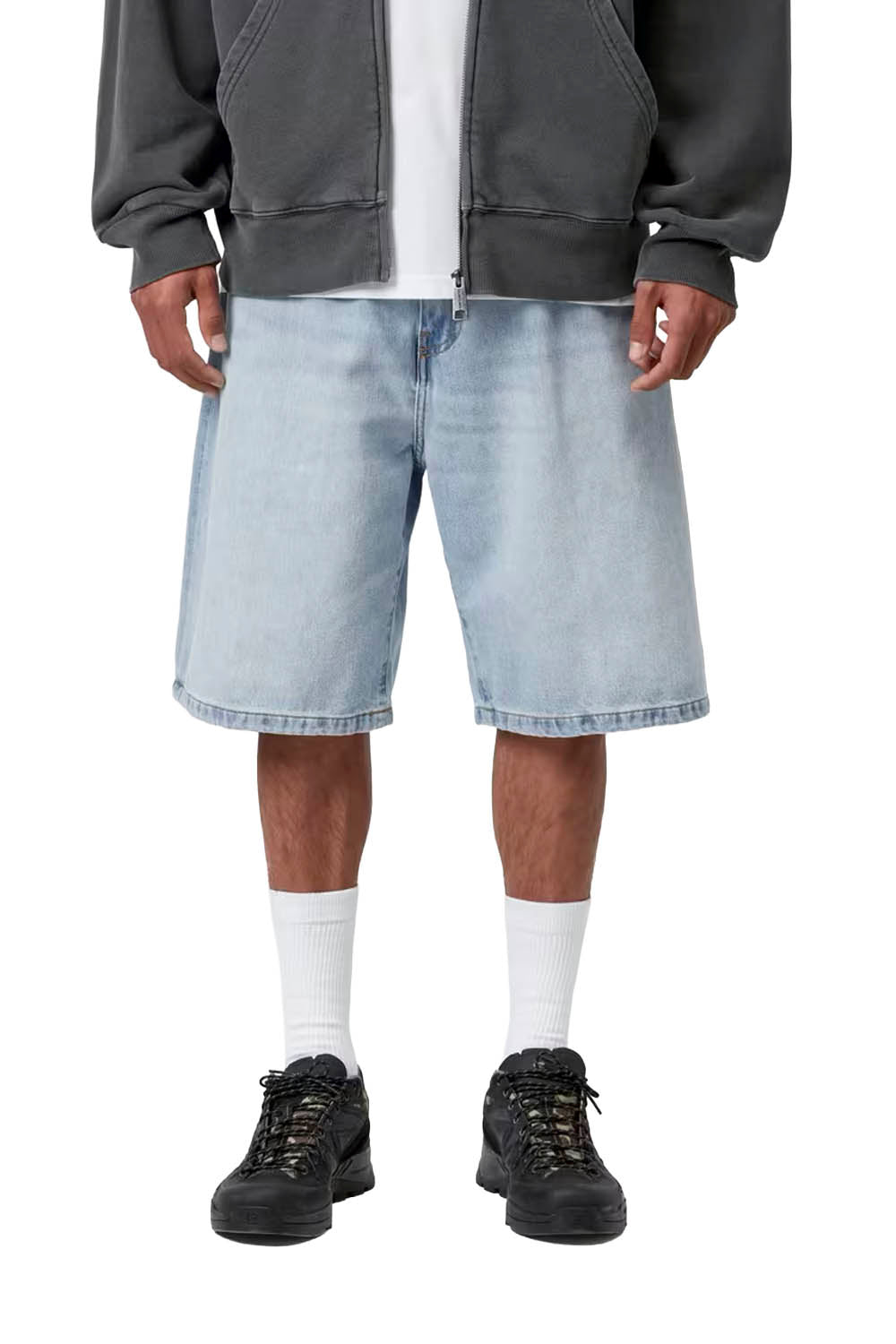 Person wearing a gray hoodie, light blue denim shorts, white socks, and black shoes on a white background