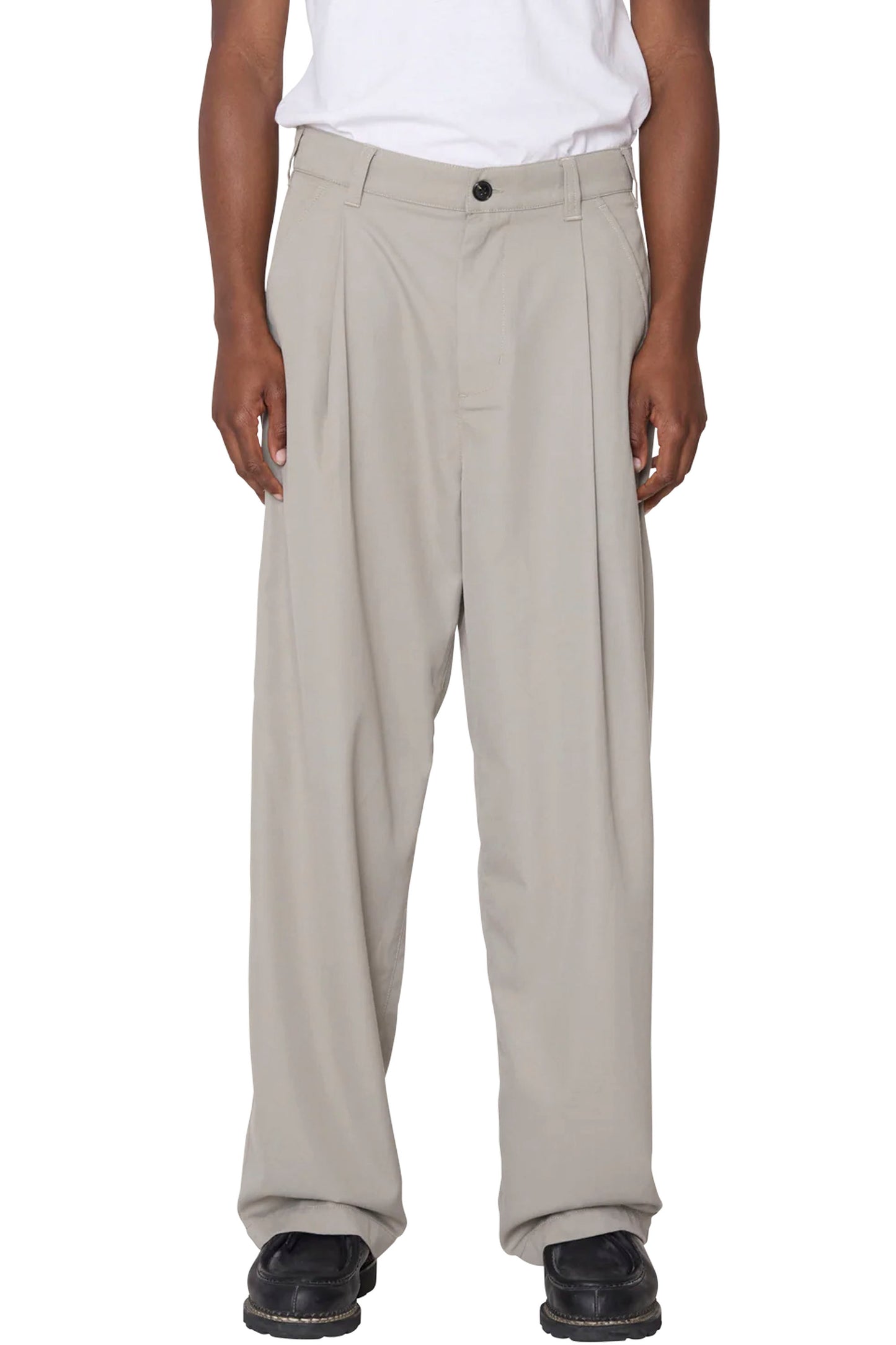 Person wearing Beige OBEY Otis pleated pants on a white background