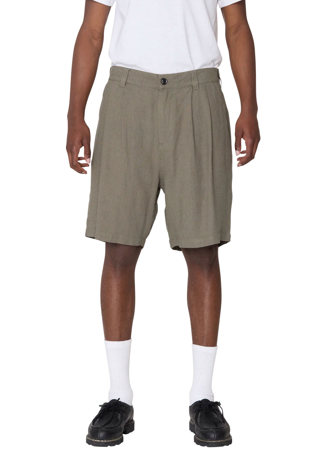 Person wearing green shorts on a white background