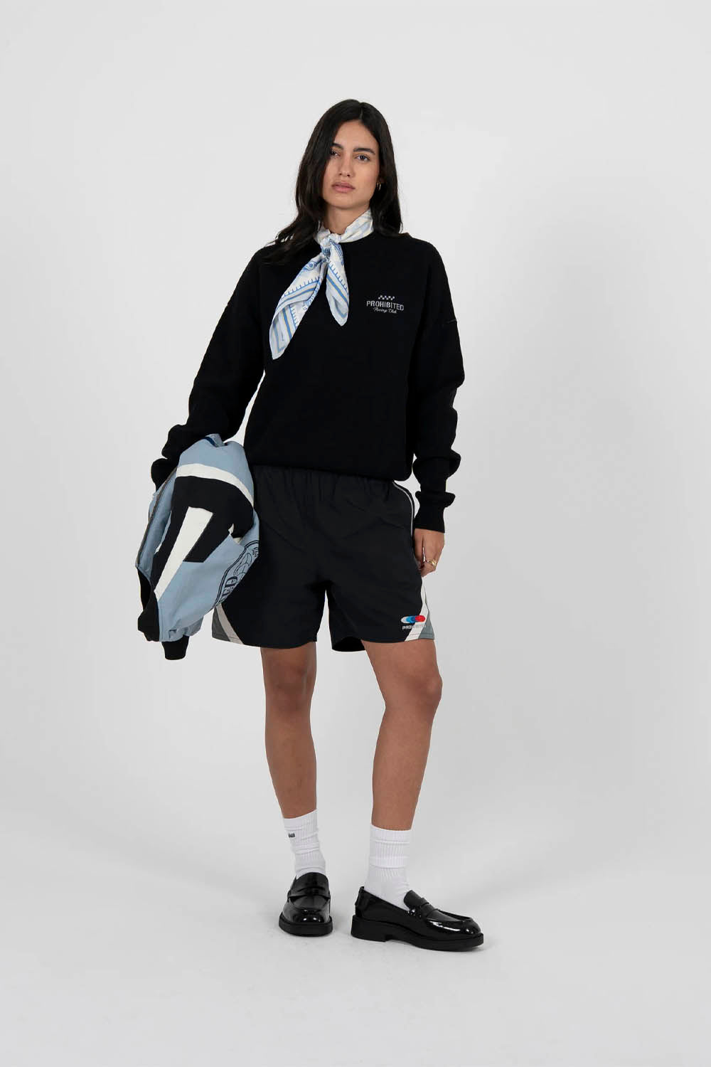 Person wearing a black outfit with a white background