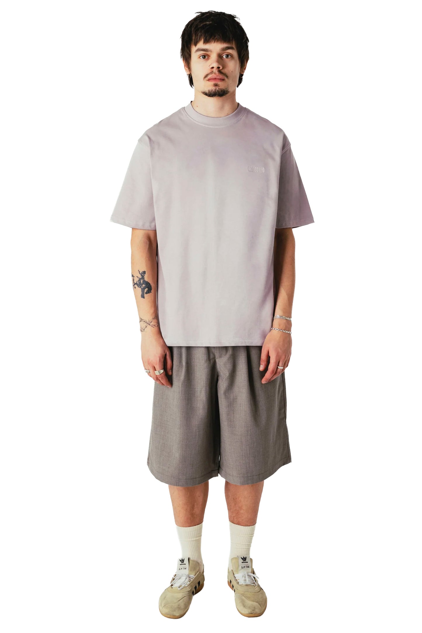 man wearing loose fit pleated shorts, wide leg silhouette