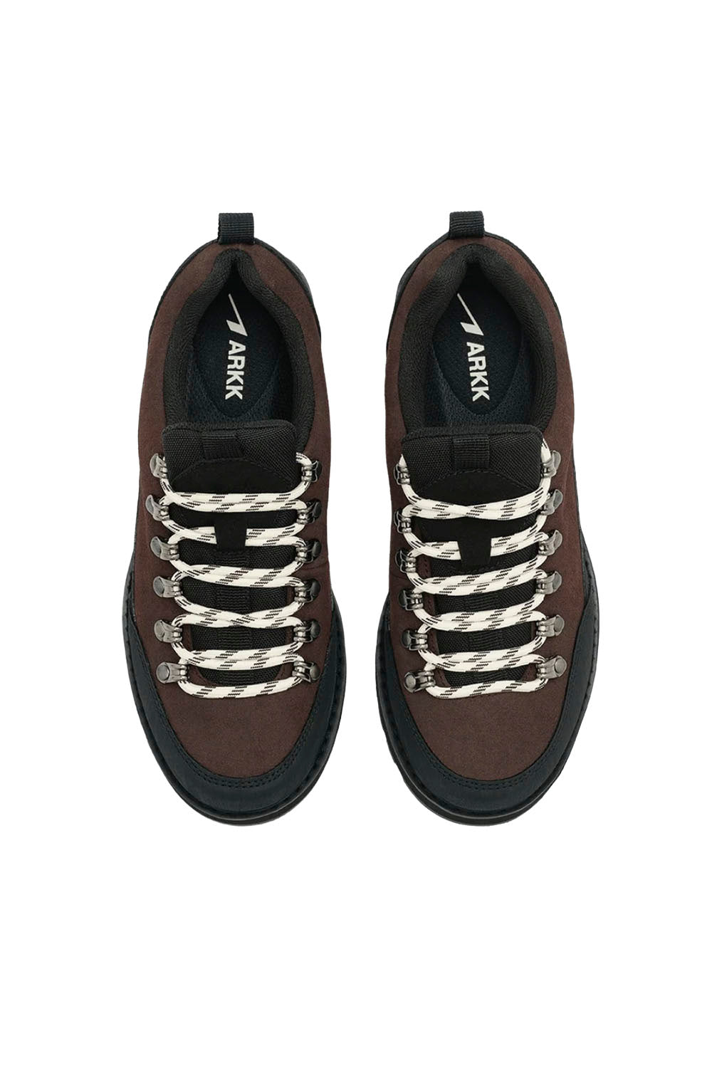 A pair of low-top sneakers shown from a top-down view on a plain white background. The shoes feature a dark brown upper, thick black soles, and distinctive braided white and black laces.