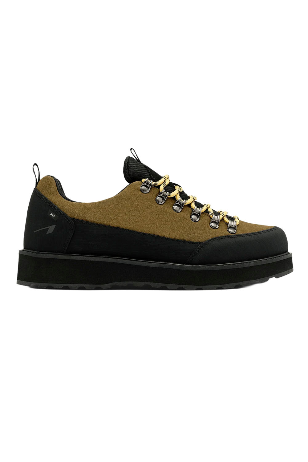 A low-top platform sneaker with a black suede upper, a tan suede side panel, black laces threaded through silver metal eyelets, and a thick black platform sole.