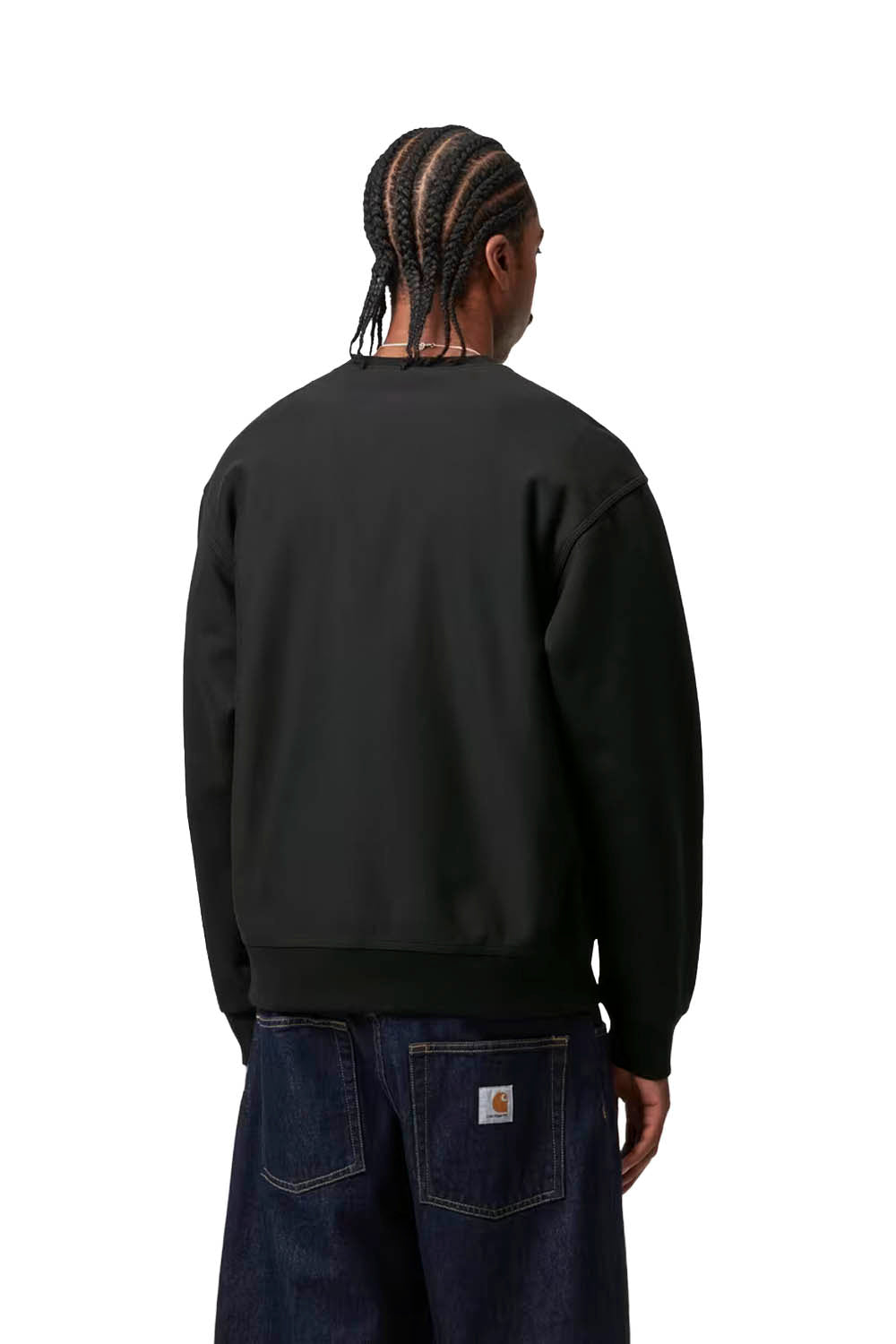 Person wearing a black sweatshirt and blue jeans on a white background