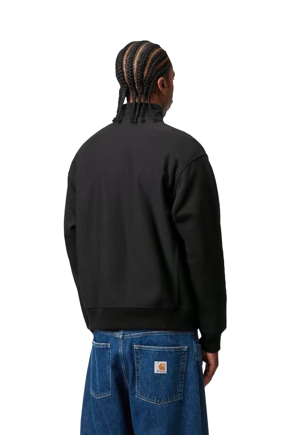 Person wearing a black sweatshirt and blue jeans on a white background